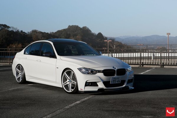 White BMW vossen tuning in open space