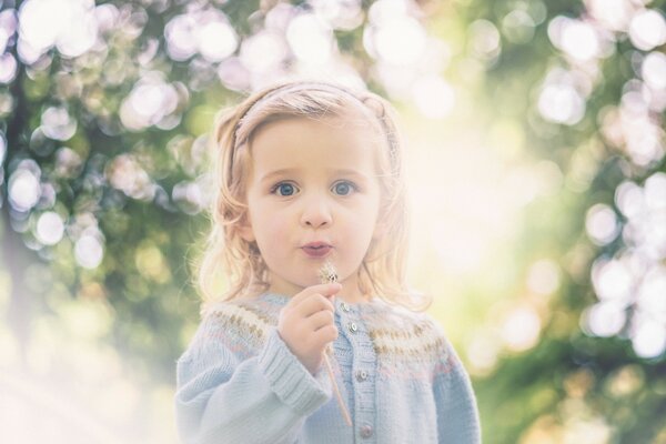 Portrait of a girl with a dandelion