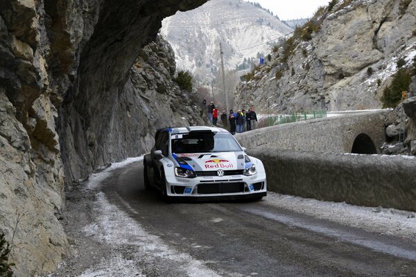 Rocks and mountains. Volkswagen car on a snowy road