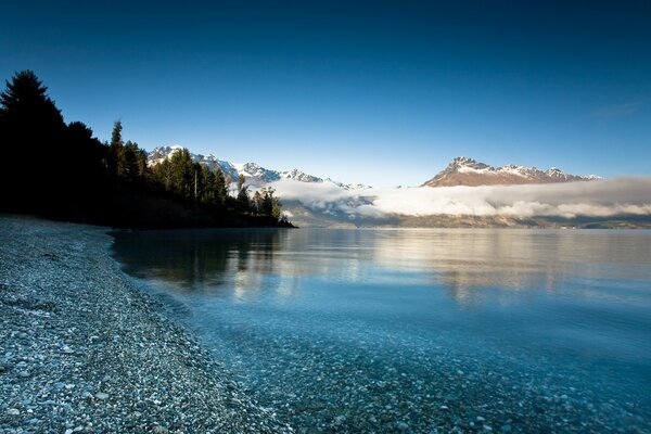 Mountains and a lake among clouds