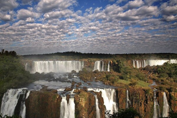 Waterfall system under transparent clouds