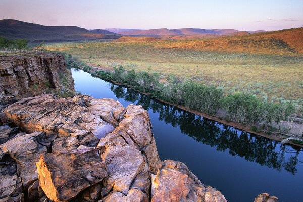 A river in America between mountains and hills