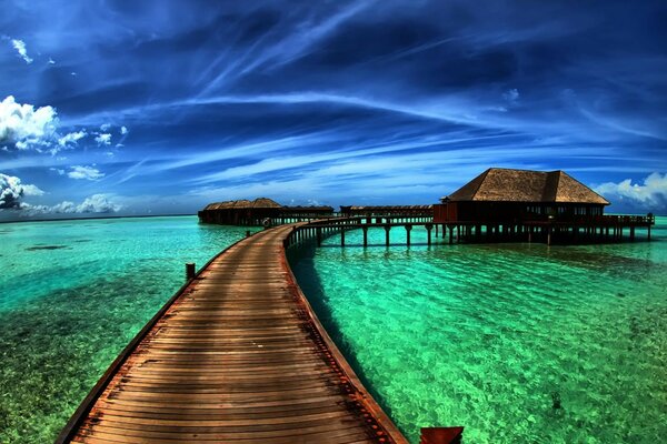 Wooden bridge to the house across the sea