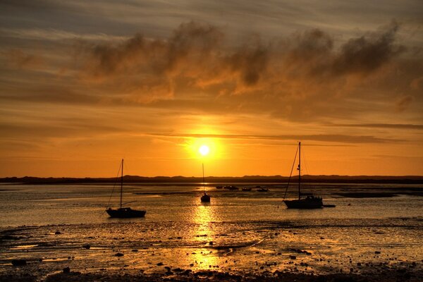 Yacht at sea with the setting sun