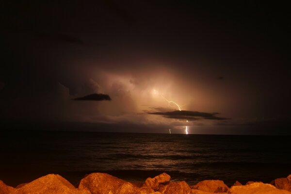 Relámpago en el cielo por la noche en el mar