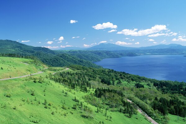 Hokkaido landscape in Japan. Grass, blue sky and water