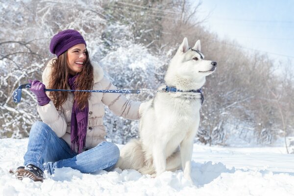 A girl with a husky dog in winter