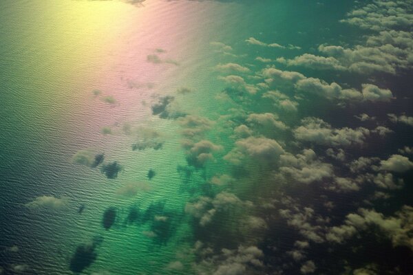 Rainbow on the background of the sea and clouds