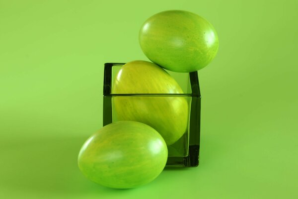 Colored green eggs in a glass