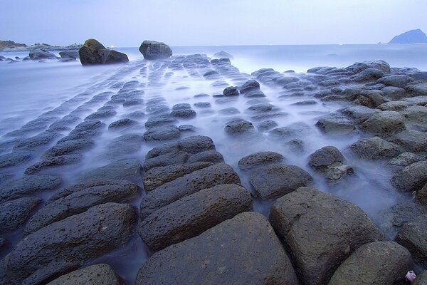 The sea with rocks in the fog