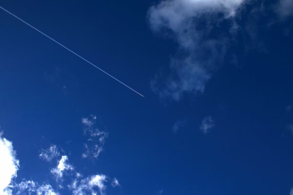 A plane flying in the blue sky