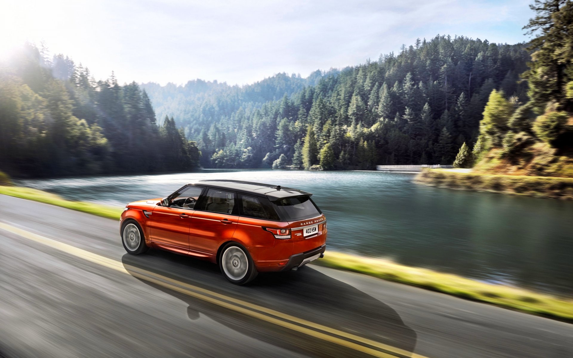 land rover range rover sport orange see wald seitenansicht auto straße