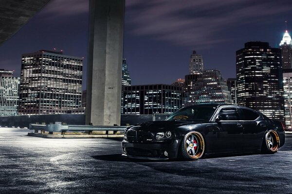 Black Dodge on the background of the night city