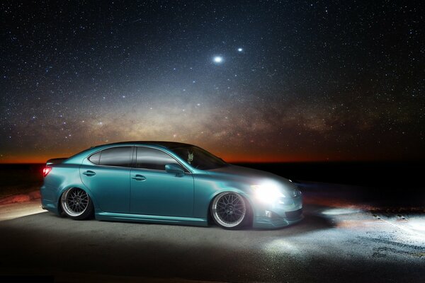 Turquoise Lexus on the background of the starry sky