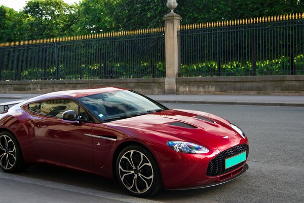 Dark red Aston Martin on the road