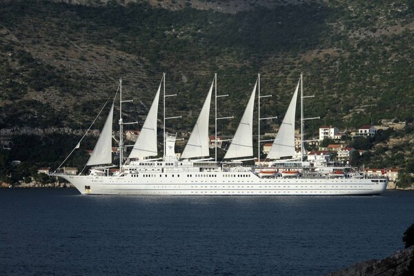 Beautiful sailboat in the sea near the mountains