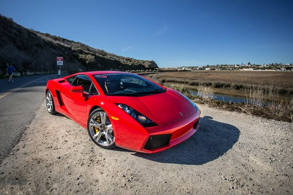 New red Lamborghini by the road