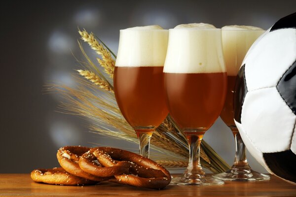 Beer poured into glasses and snacks