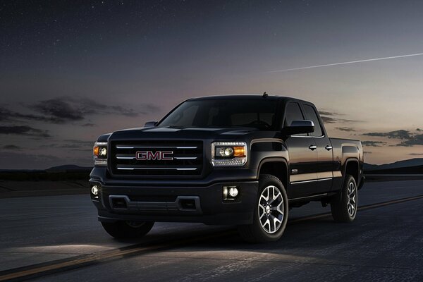 Black pickup truck under the night sky