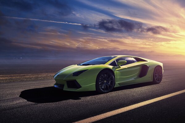 A green Lamborghini car in the rays of the setting sun