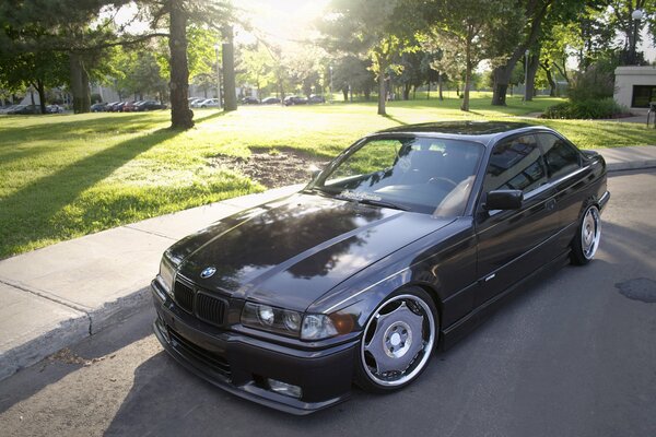 Black tuned BMW E36 under the sun