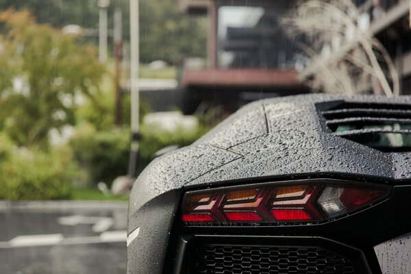 Lamborghini aventador in the rain taillight view