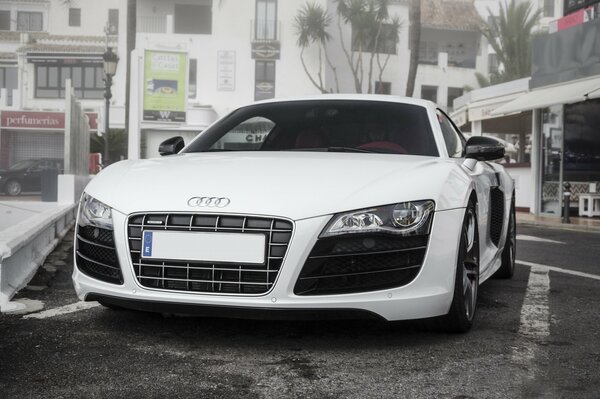 White audi in the parking lot near the store