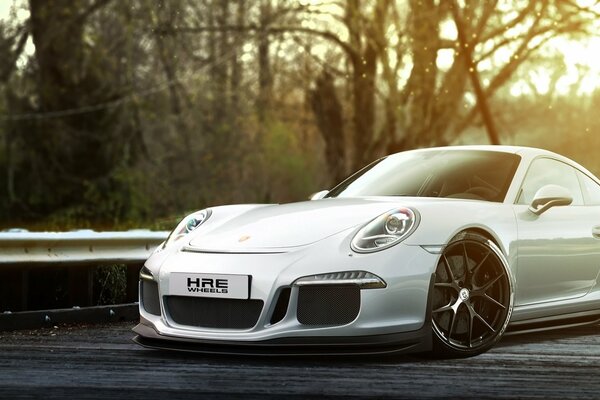 White Porsche on a forest background