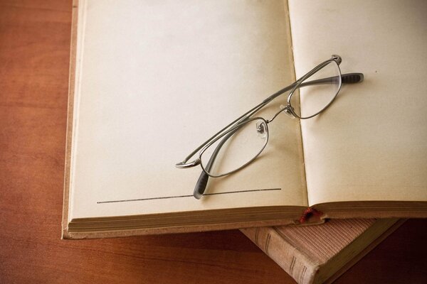 Glasses on a book with blank pages