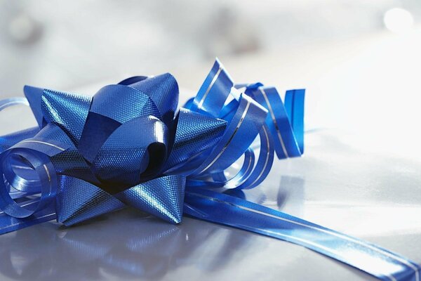 A gift tied with a beautiful bright blue ribbon