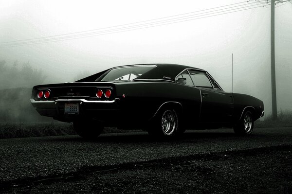 An old Dodge in a black fog