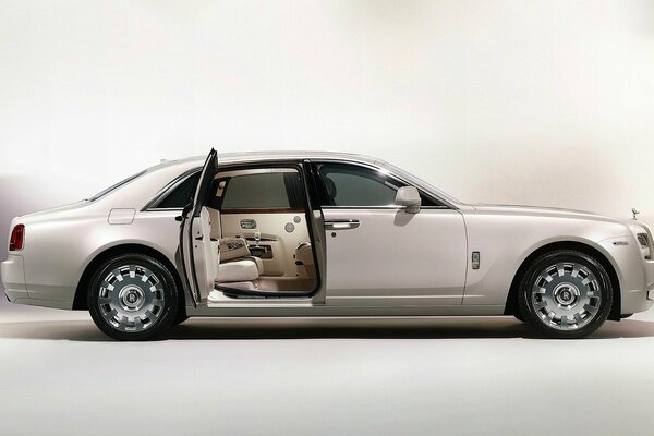 The snow-white interior is visible through the open door of a white Rolls Royce