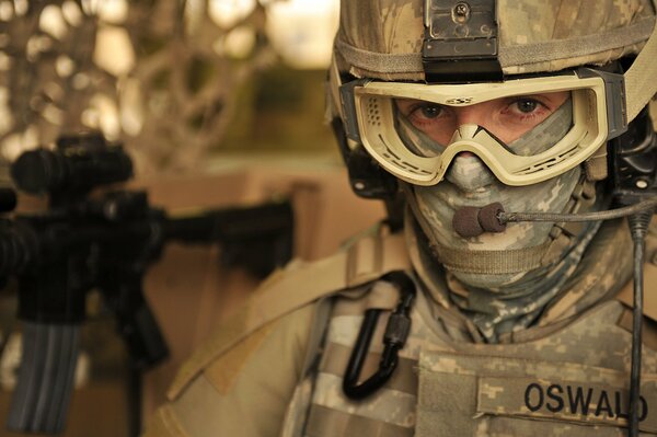 An American soldier with glasses speaks into a microphone