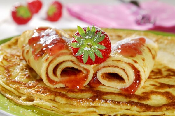 Pancakes with strawberry jam and fresh strawberries