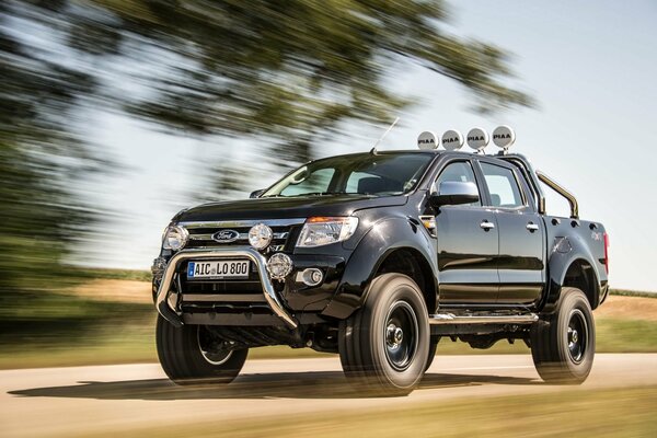 Ford rushes along a country highway