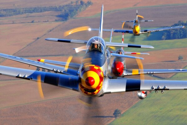 A group of planes flying over the field