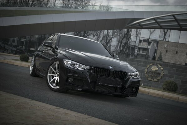 Tuned black BMW in an urban environment