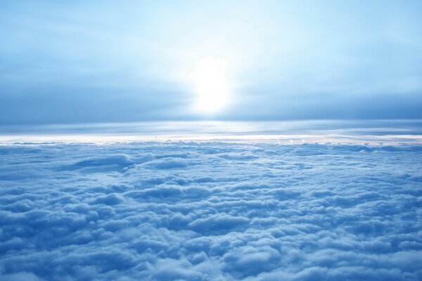 White sun above the clouds