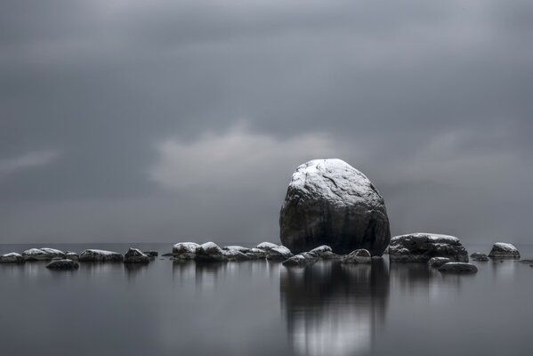 Reflection of a stone in water in black and white