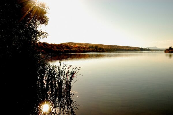 The rays of the sun play warm on the lake