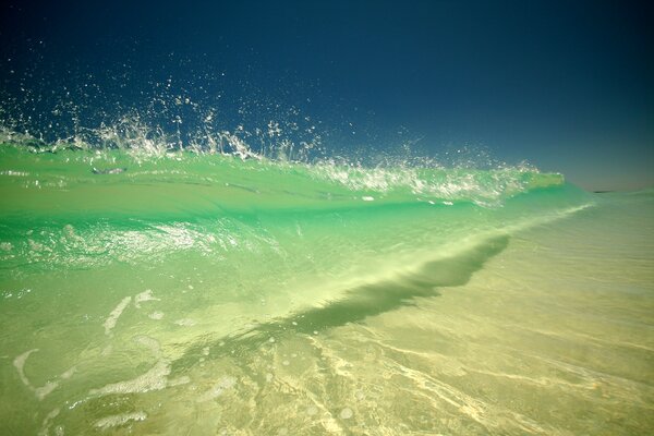 Emerald ocean waves rolling on the shore