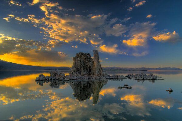 Rocher au milieu de la mer au coucher du soleil