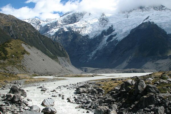 The river stretches to the snow-capped mountains