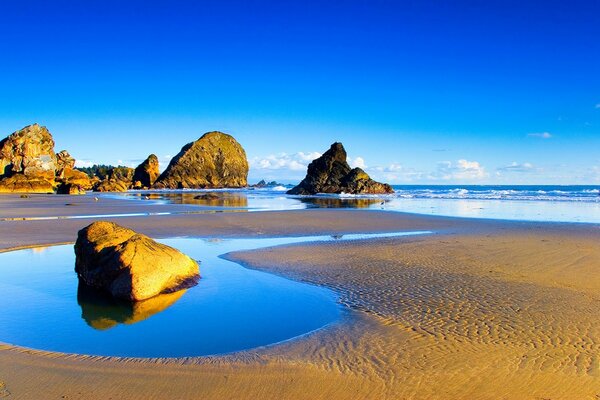 Stones on the sand by the sea on a sunny day