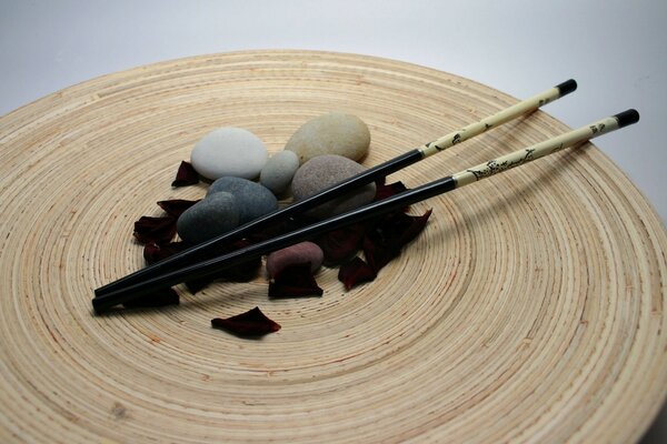 Japanese sticks with stones and rose petals