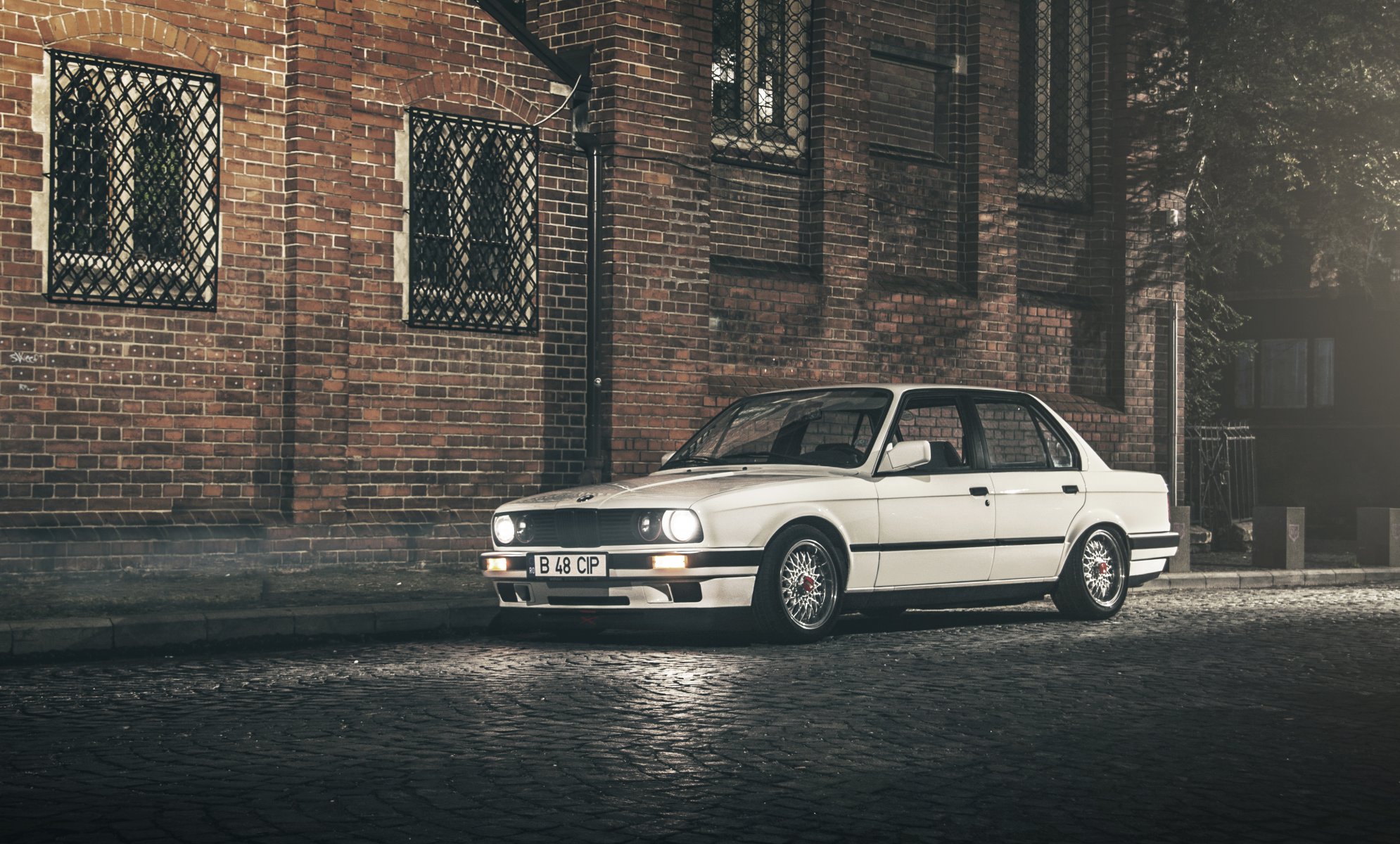 bmw 3 series e30 sedan white street building