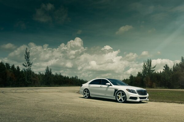 White Mercedes Benz on a country road