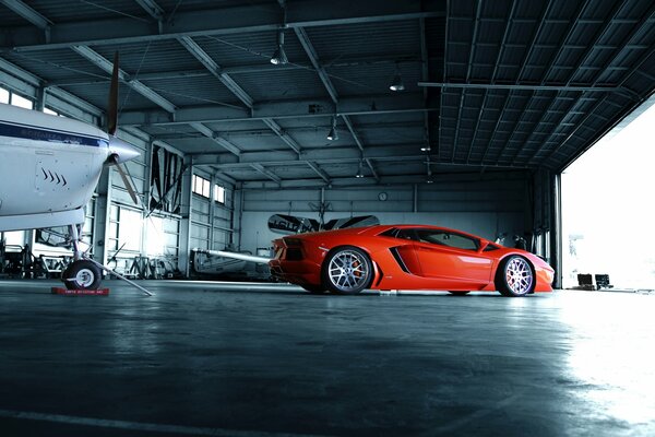 Orange lamborghini aventador car in the hangar