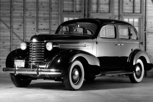 Retro car on the background of a wooden building