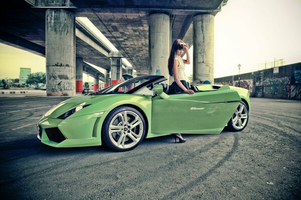 A girl stands near a lamborghini salad